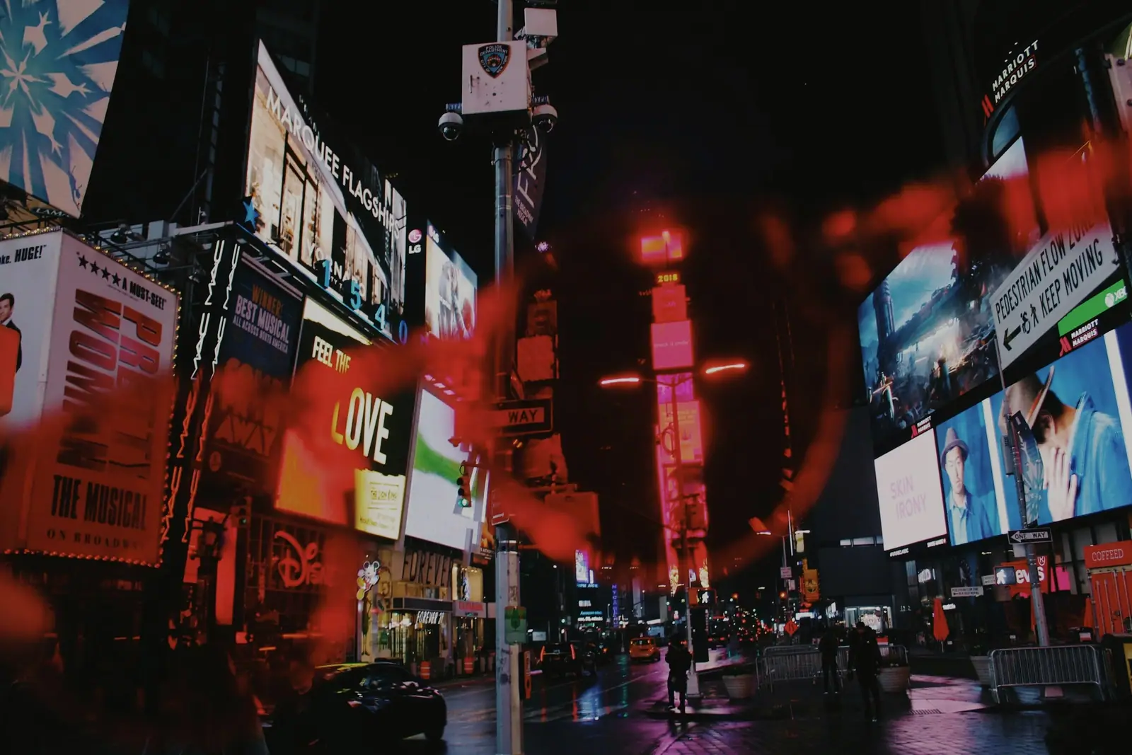 Crowded advertising signs at night, graded as warm grainy film
